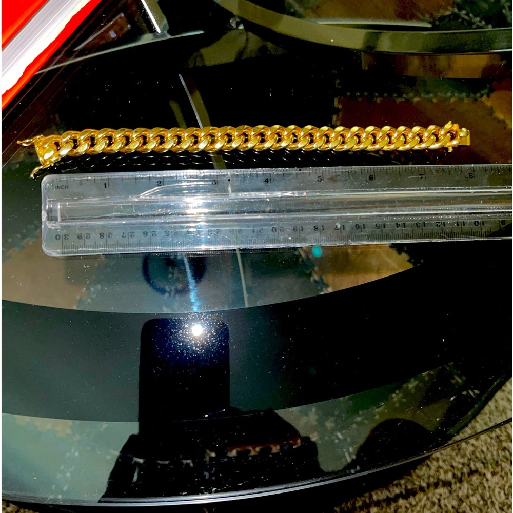 12 mm wide / 8 inches long yellow gold cuban link bracelet. $1400.00